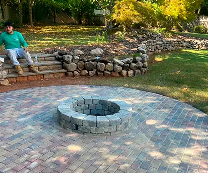 Round stone fire pit on a paver patio